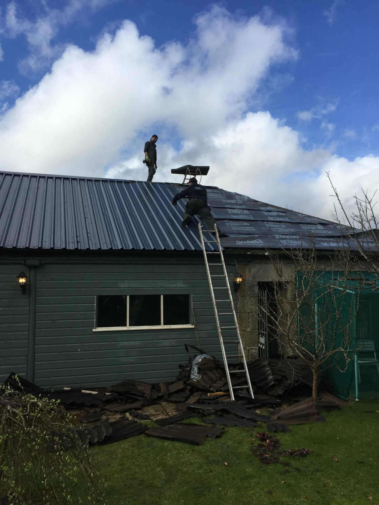 New box-profile metal roof replacing old corrugated sheets
